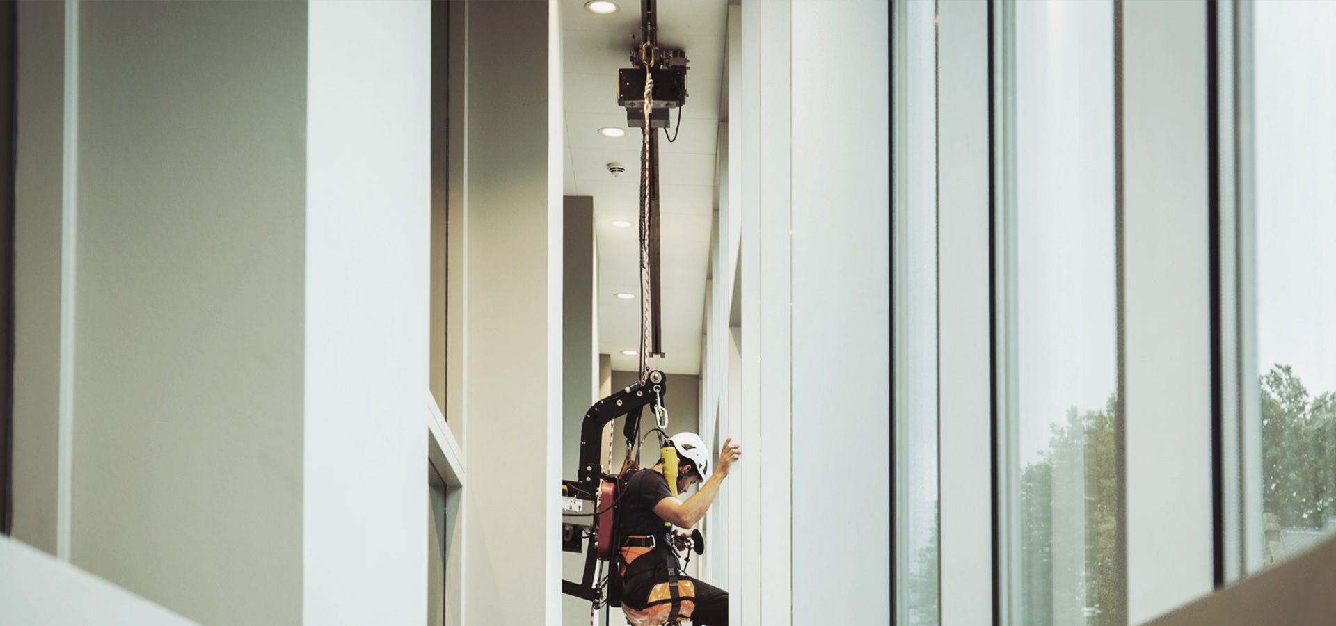 A RopeClimber hoist to clean a cultural center