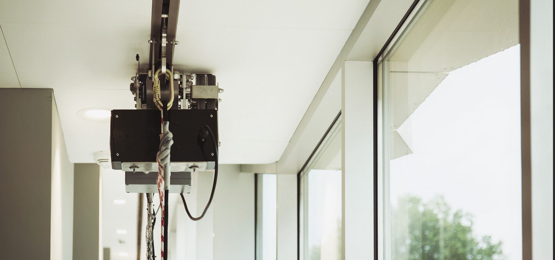 A RopeClimber hoist to clean a cultural center